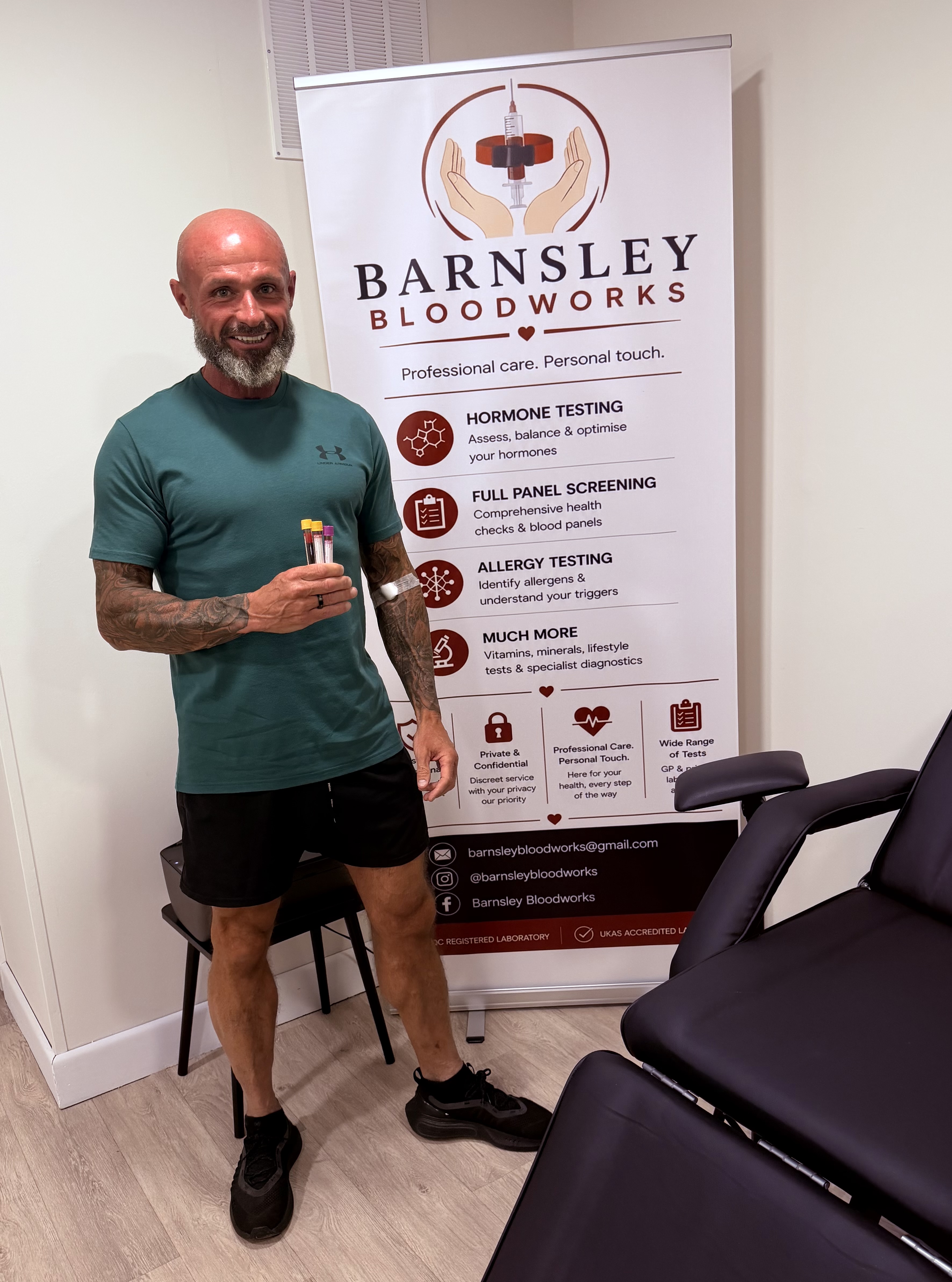 A Barnsley Bloodworks client holding blood sample tubes after a test